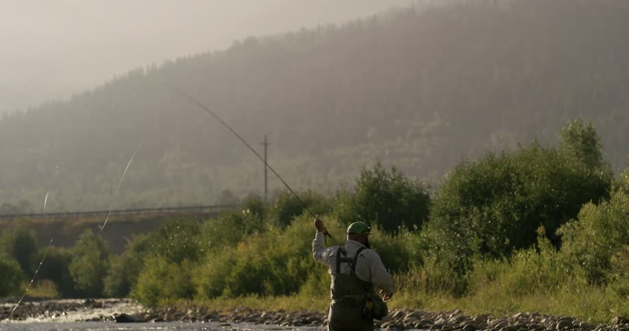 Man fly fishes on a river