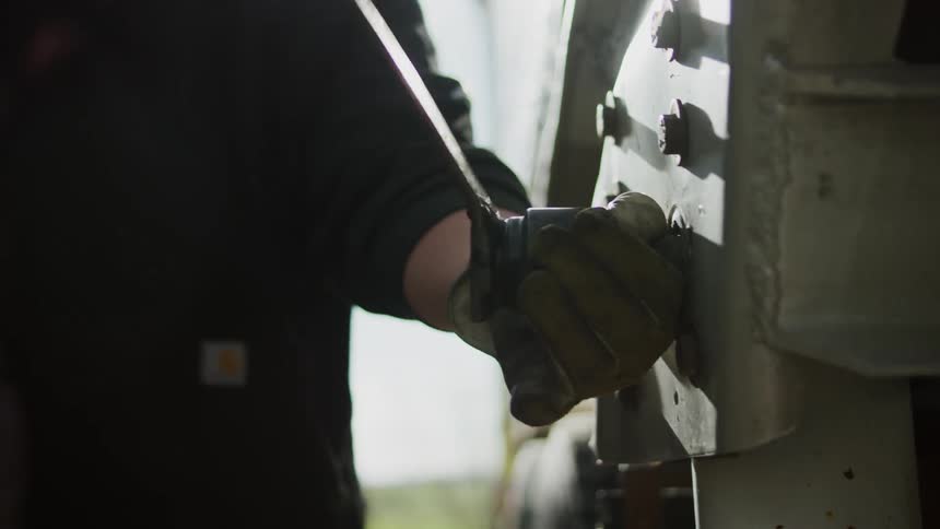A man is working on a machine repairing it