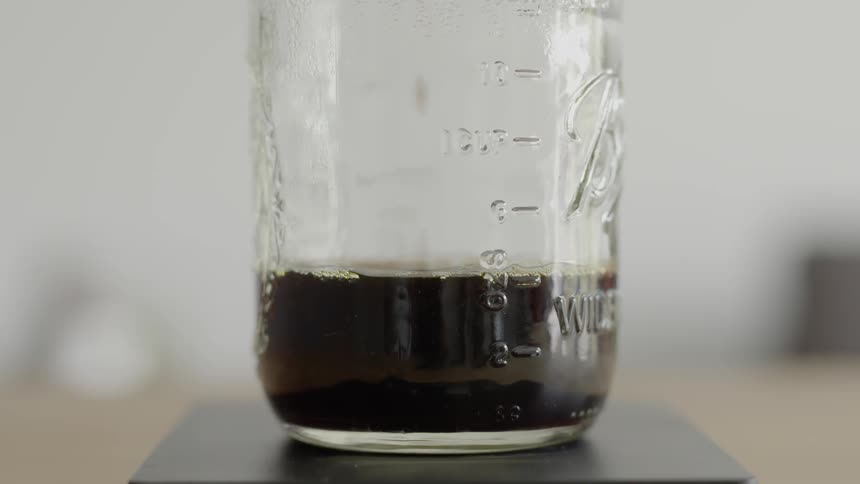Liquid drips into a mason jar