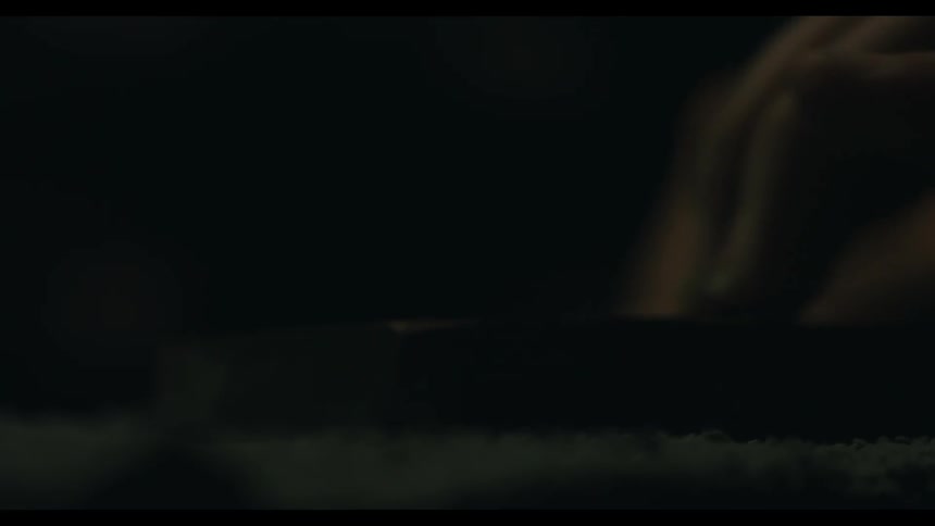 A hand is holding a scraper and is scraping something