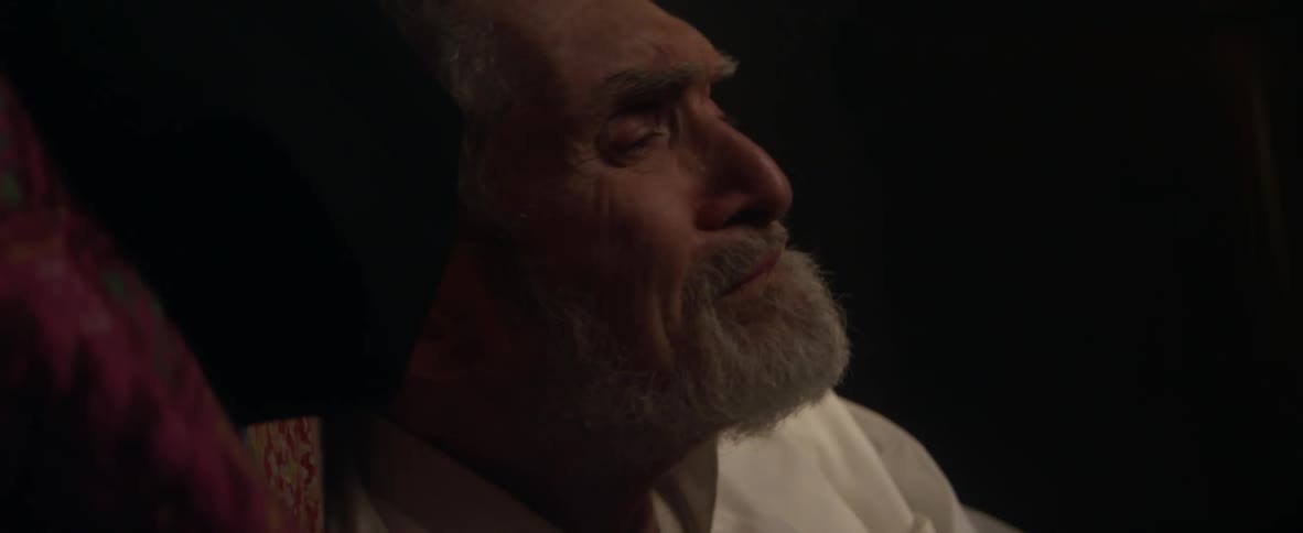 An elderly man shakes his head in sadness