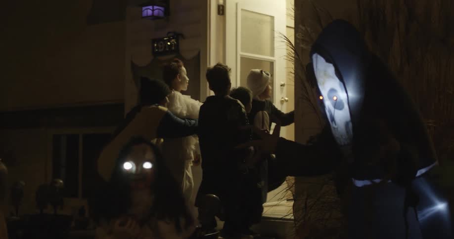 A group of kids are trick or treating