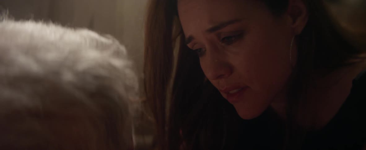 A woman cries while talking to an elderly person