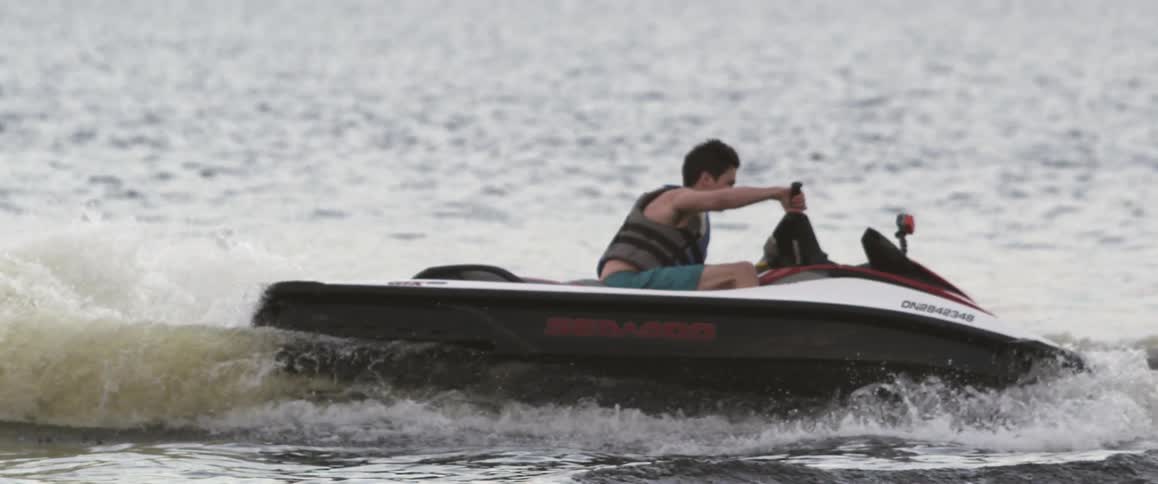 Man circling on jet ski in open water