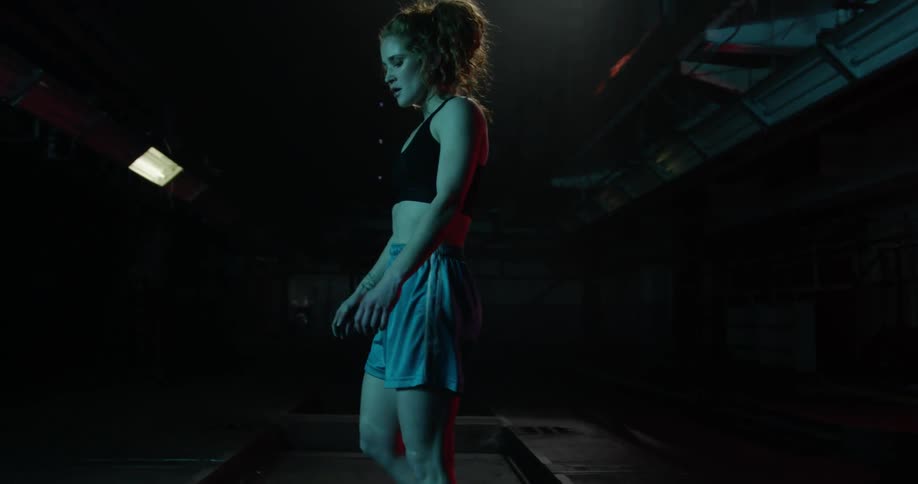 A woman leans over and catches her breath