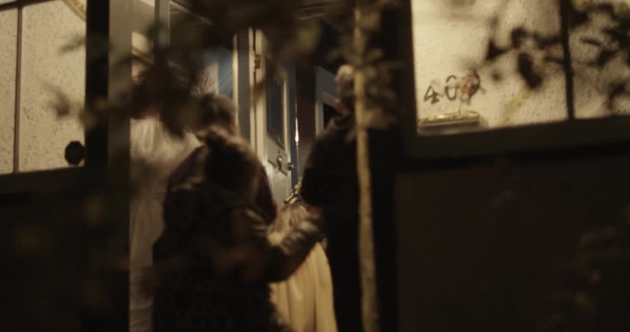 Children trick or treat at a front door