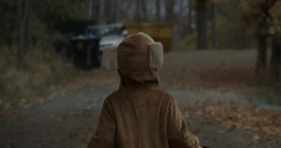 A young child in costume goes trick or treating