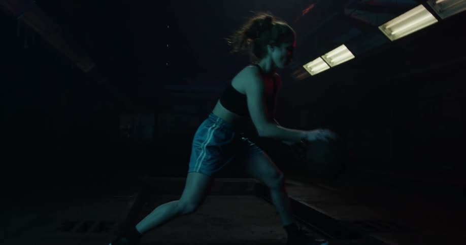 Woman bounces a basketball on the floor