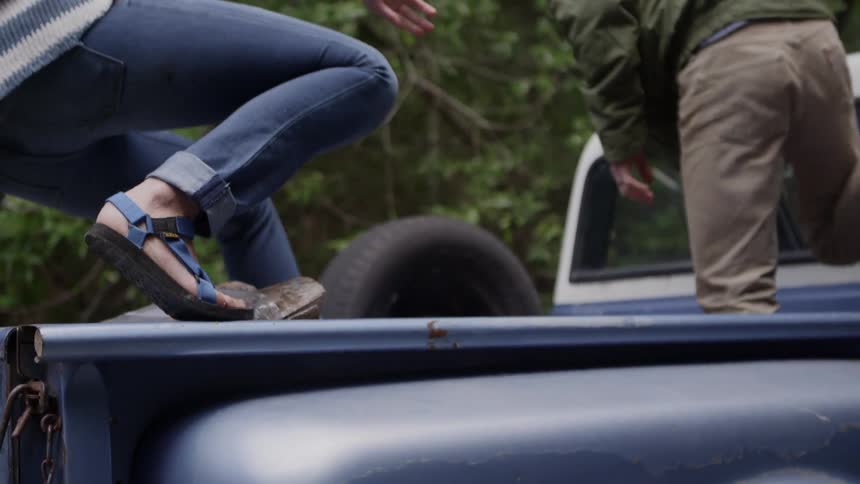 People climbing up into a truck and sitting