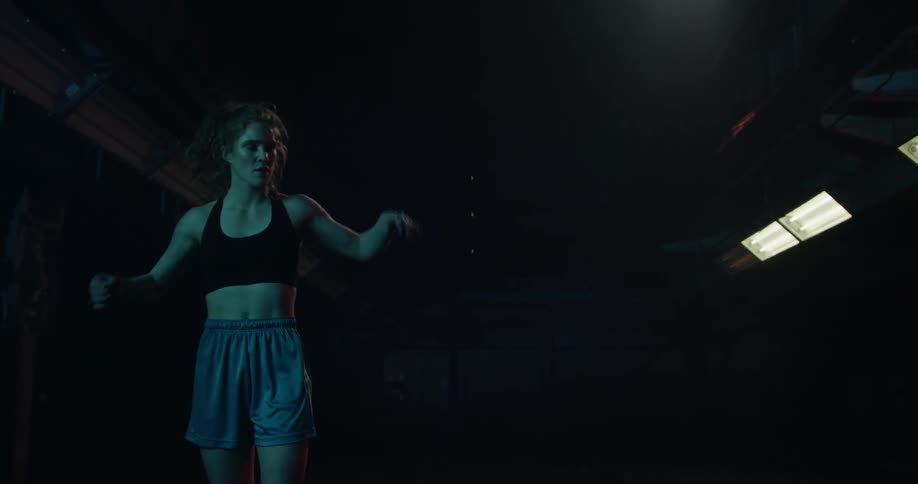 A woman kicks a basketball in frustration