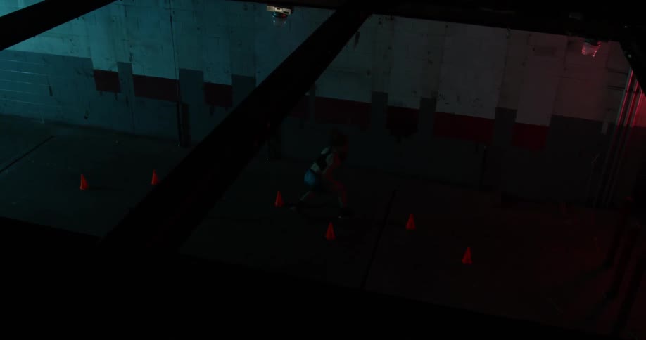 A woman dribbles a basketball through a cone drill