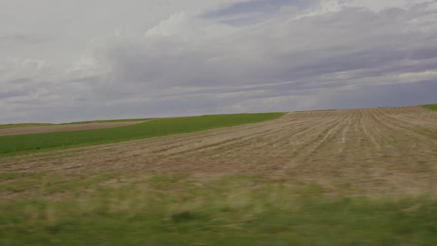 Clouds float over a rural field