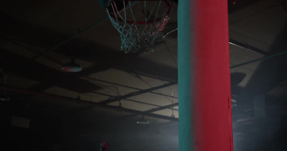 A woman shoots a basketball and scores