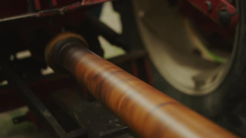 A piece of equipment rotates next to a tire