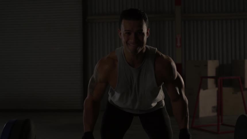 A man performs several reps of a barbell bent row