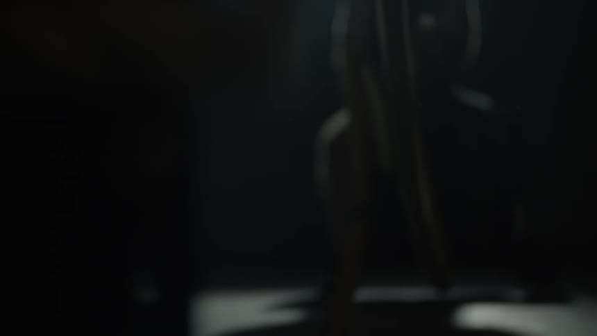 A man pulls ropes in a gym