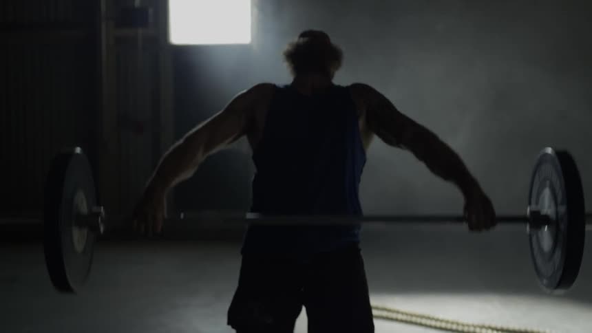 A man deadlifts above his head