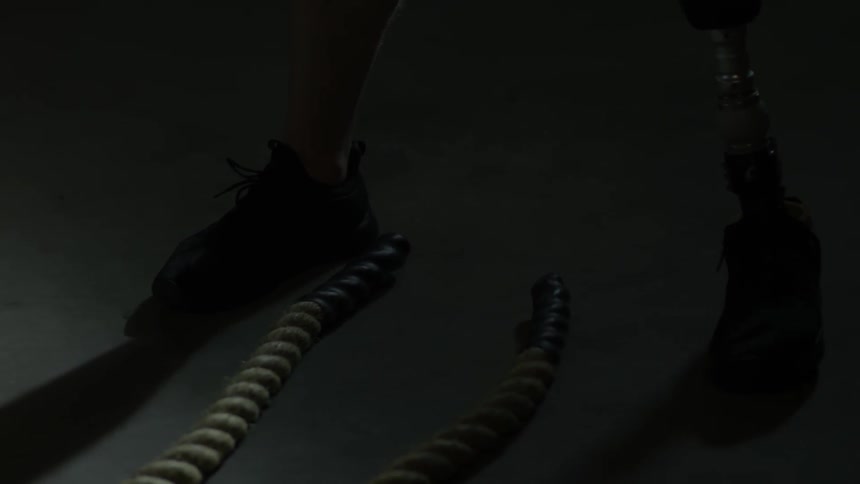 A man with one leg is using ropes to exercise