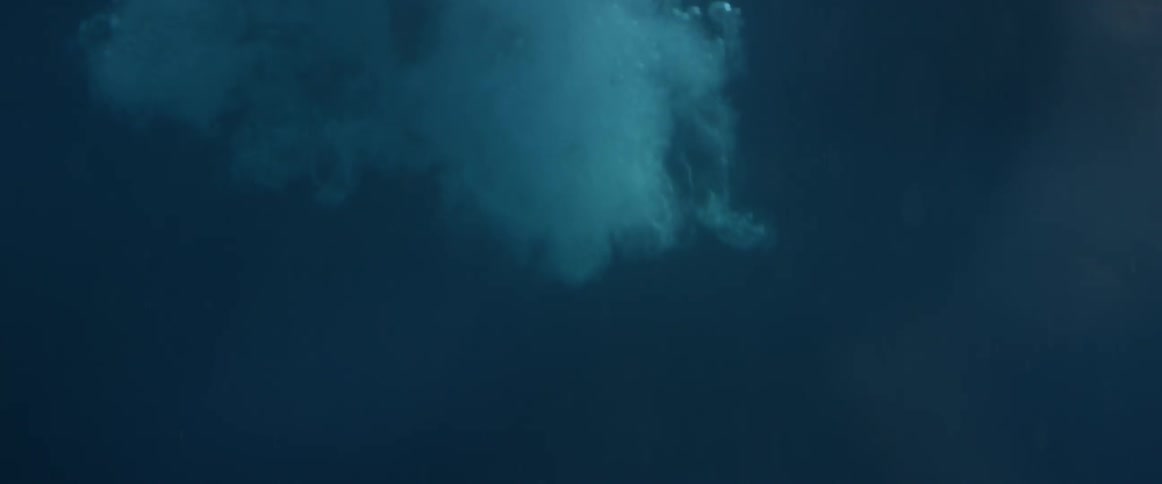 Man drops into a body of water feet first