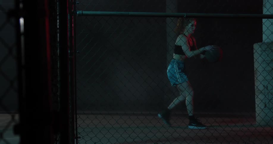 A woman shoots and dribbles a basketball