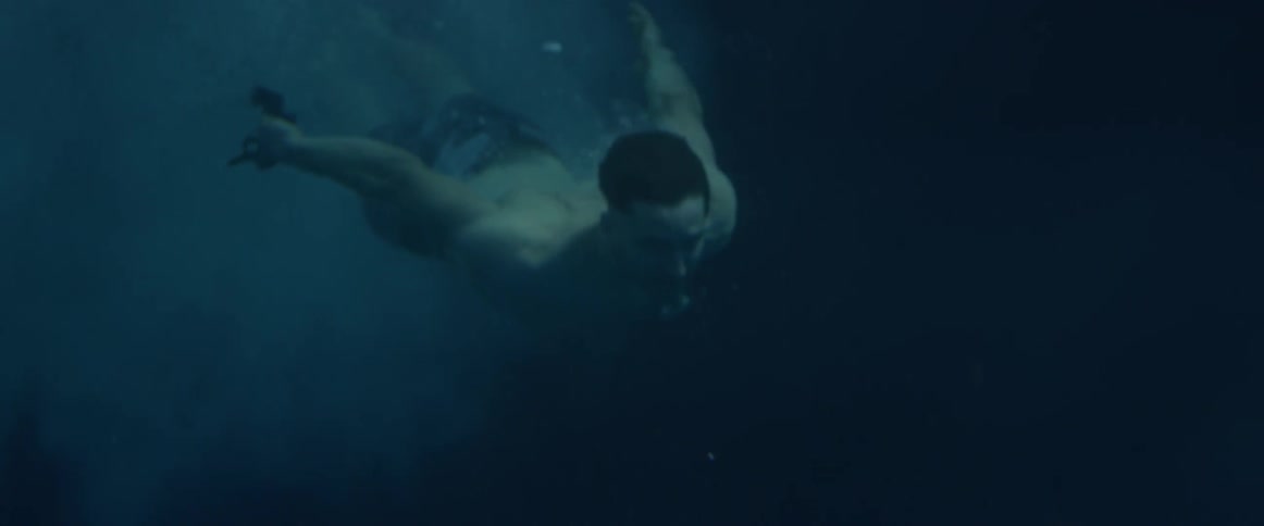 A man jumps into a body of water
