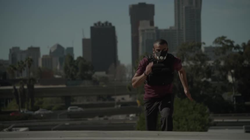 A man races up the steps before a city