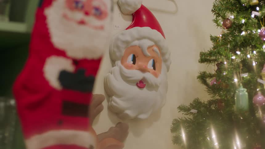 A santa stocking and ornament are in this home near a tree