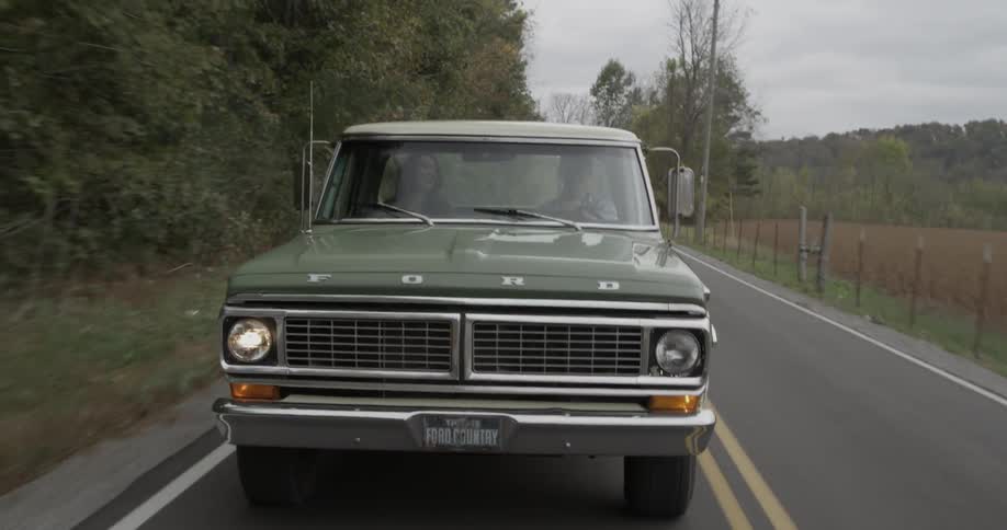 An old pickup truck is driven in a rural area