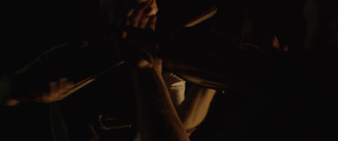 Two men are playing the violin at night