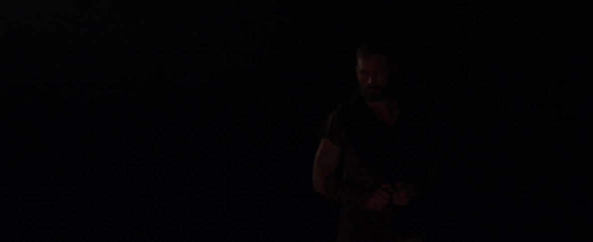 Man standing in the dark with something in his hand