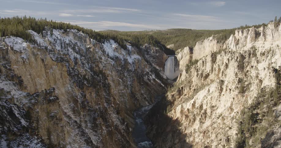 Stream flows through mountains on a sunny day