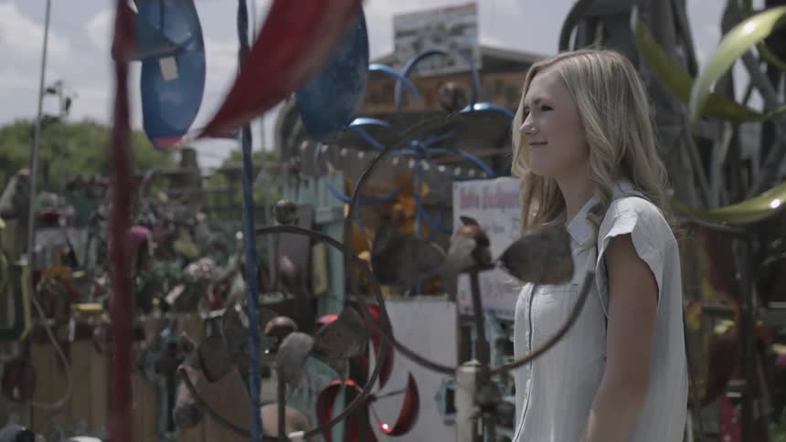 A woman is taking a picture in a flea market