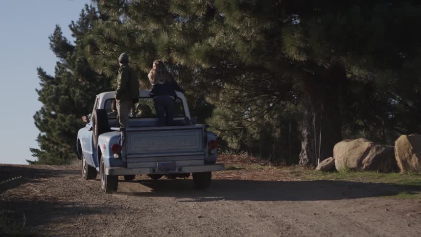 People standing behind on a pickup truck