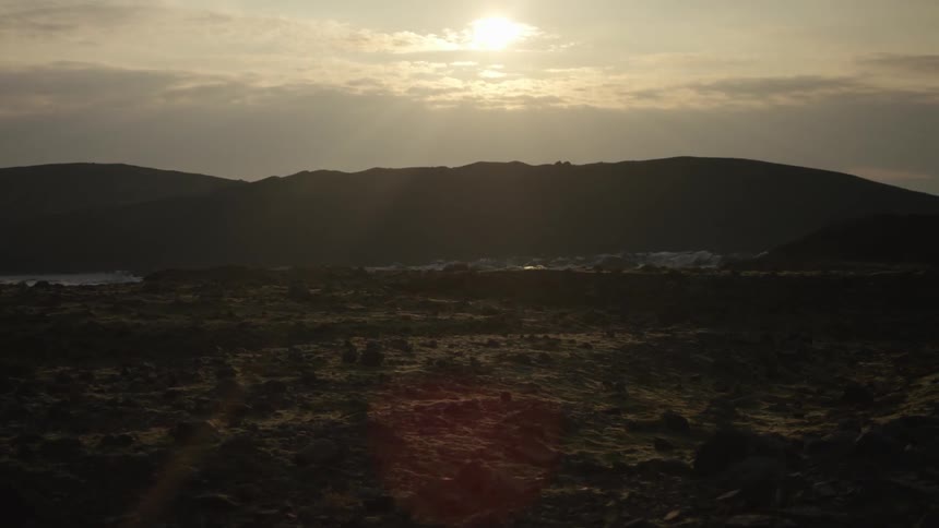 A mountain range in the distance on an overcast day