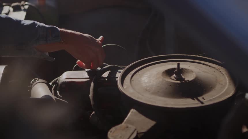 A person touches a hot motor