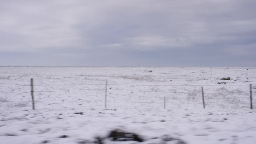 An open field is covered with snow