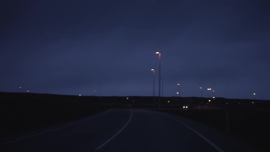 A two lane highway at night