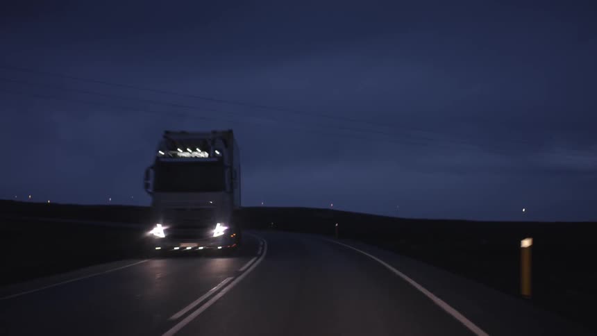First person perspective of driving on a two lane highway at night