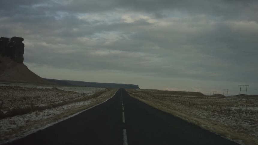 First person perspective of driving down an empty desert highway