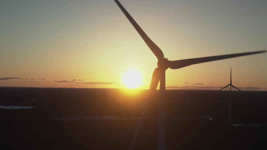 The windmills slowly turn as the sun sets