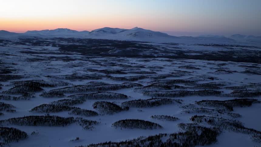 Snow and ice covers the hilly landscape