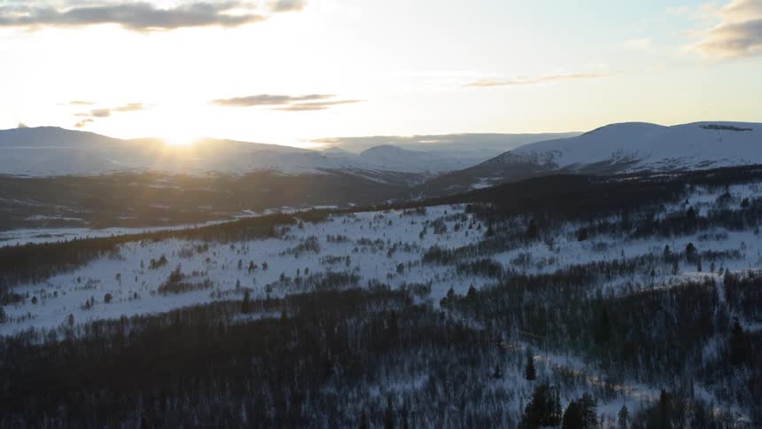 Sun rising over a frozen landscape
