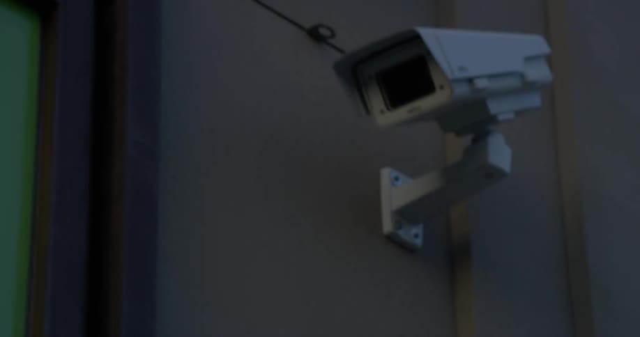 A camera is planted on the side of the building