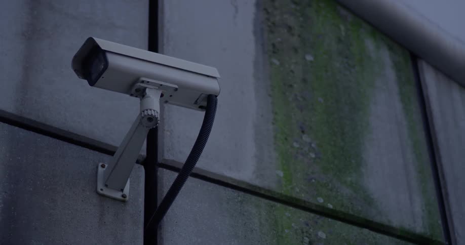 A security camera is placed on the side of the building