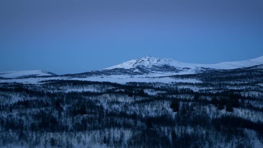 The mountain far ahead is covered with ice