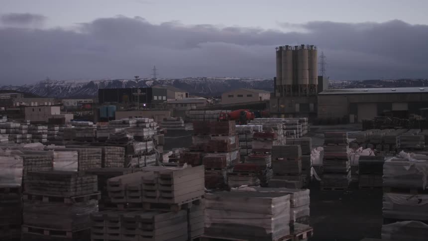 An industrial site in a city on a cloudy day