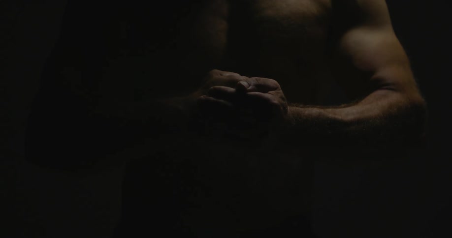 A man clenches his fists together