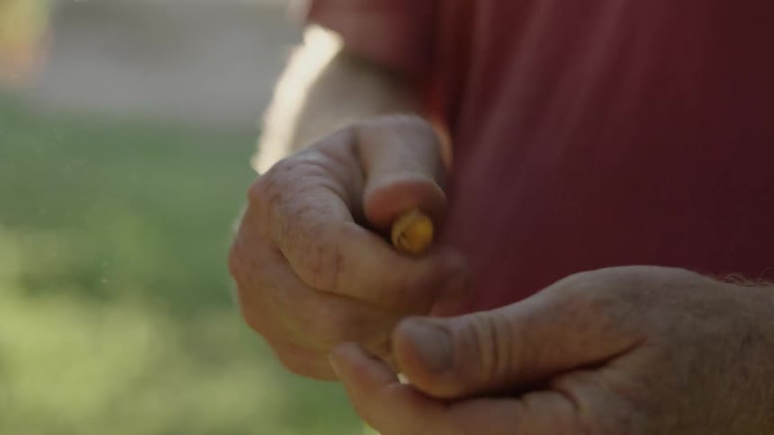 A man is shelling a nut