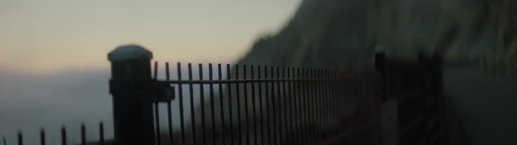 The iron gate covers the mountain near the water