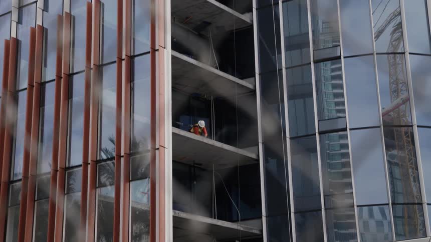 A construction worker works on a high rise